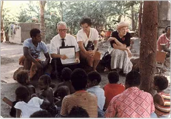 missionary couple teaching group of people