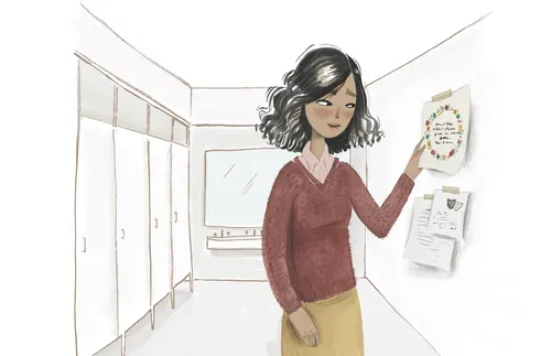 woman looking at paper on a wall