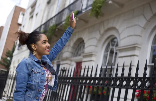 Woman waving from the street