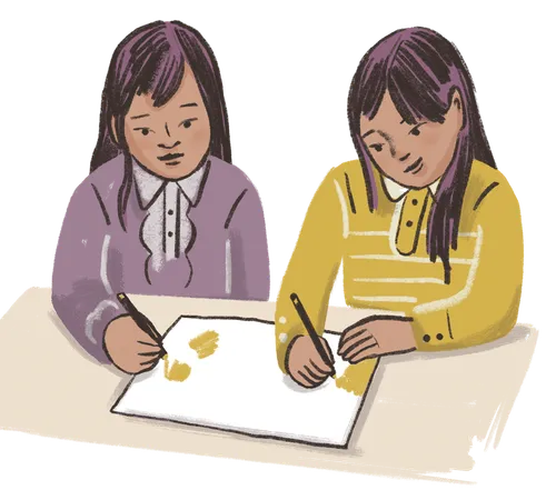 Two girls drawing on a piece of paper