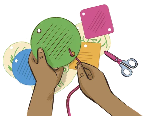 Child’s hands with cut-out paper shapes