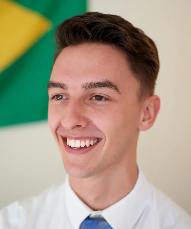 A missionary models appropriate dress and grooming. He is wearing an approved shirt and tie and has an approved haircut.