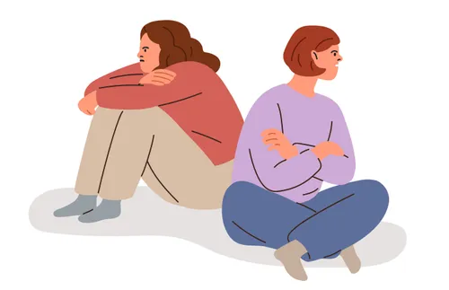 two people sitting with backs to each other