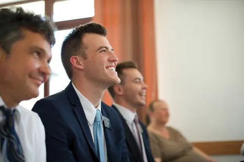 Two elder missionaries smiling while sitting between a man and woman in a Church meeting in Romania.