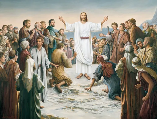 Jesus Christ in white robes and a red sash stands in the midst of a large group with His wounded hands outstretched.