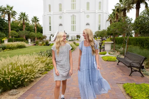 a group of young women walk outside the temple together