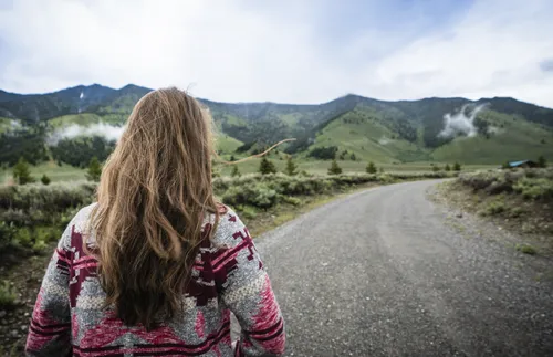 Woman looking down road
