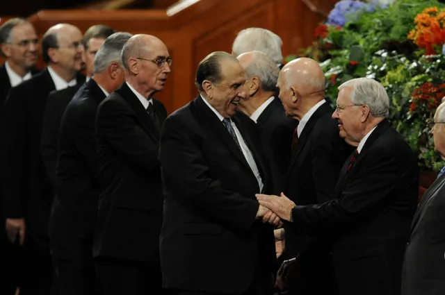 Elder M. Russell Ballard shakes the hand of  President Thomas S. Monson at the October 2010 General Conference.