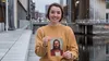young woman holding a picture of the Savior