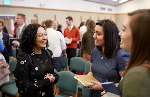 a group of women laughing and smiling at church