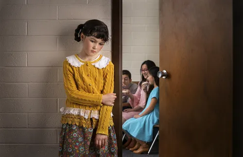 girl standing outside of classroom