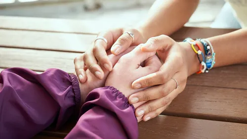 young women holding hands