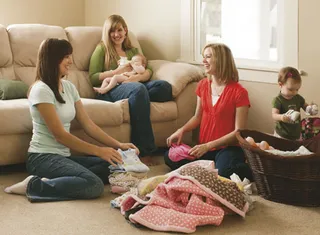 women folding laundry