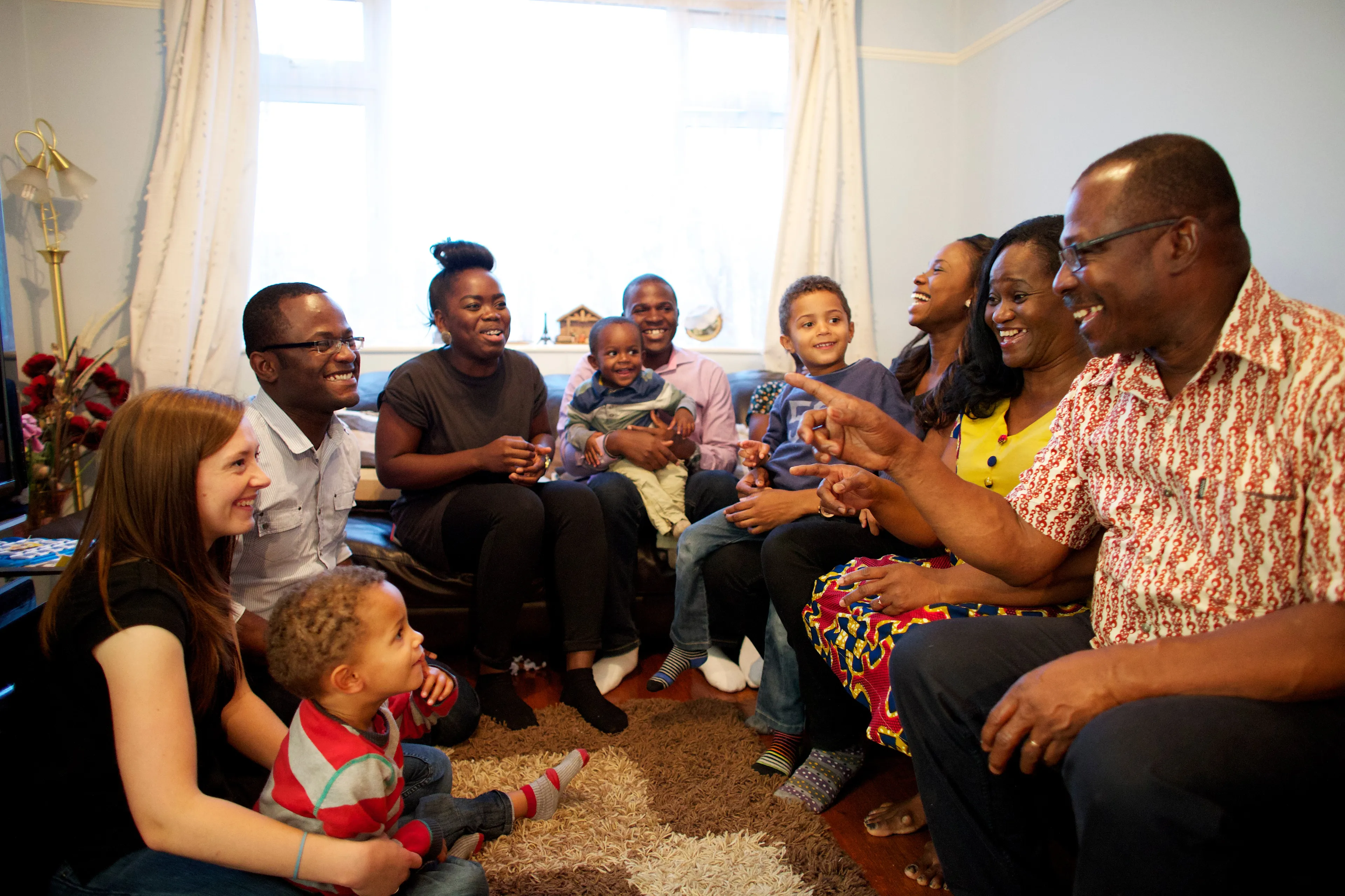 A family sitting around and talking during family home evening.  