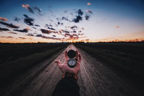 hand holding a compass