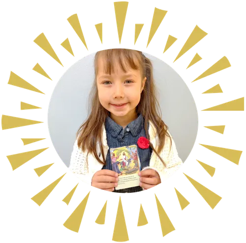 A photo of Kosette Decker holding a picture of Jesus riding a donkey.