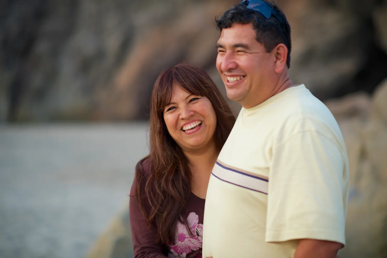 A couple stand on a beach looking out to sea contemplating the Book of Mormon