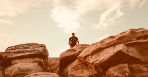 man standing on a cliff