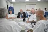 Inmates sit around a variety of tables. Around them are other men and women instructing and helping them.   Special Services of the Priesthood department has requested that PSD capture images of various Correctional facilities that will be used on websites and curriculum targeted to spiritually support LDS members in correctional confinement and their families.