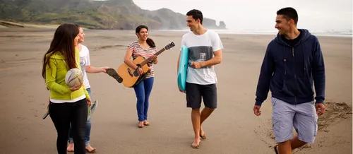 Friends at a beach walking and socializing.