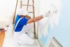 man paiting wall