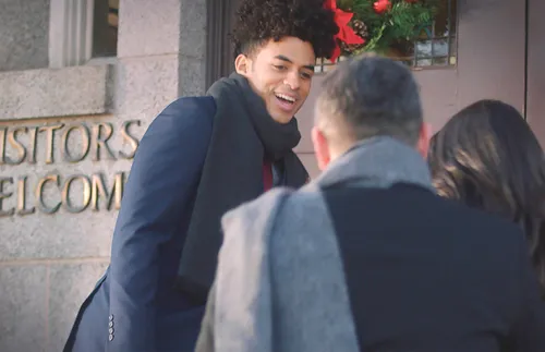 young single adult greeting a couple entering church