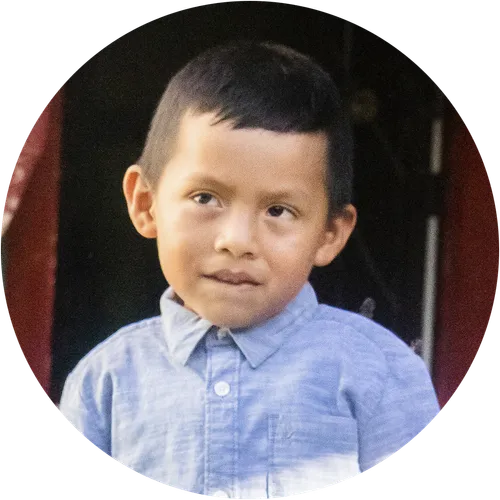 A little boy wearing a blue collared shirt