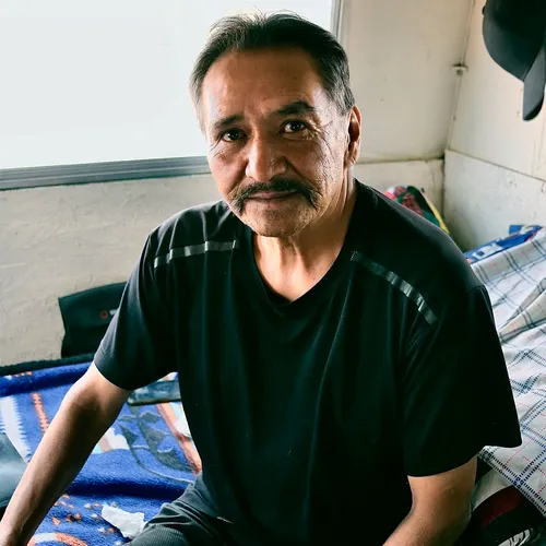 man sitting in his home