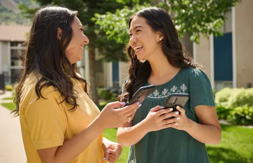 two women laughing and talking