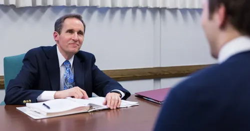 Church leader meeting with young man