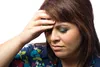 Woman holding forehead