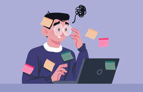 man typing on a computer and looking confused