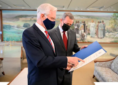 Elder Christofferson and Elder Bennett looking at document