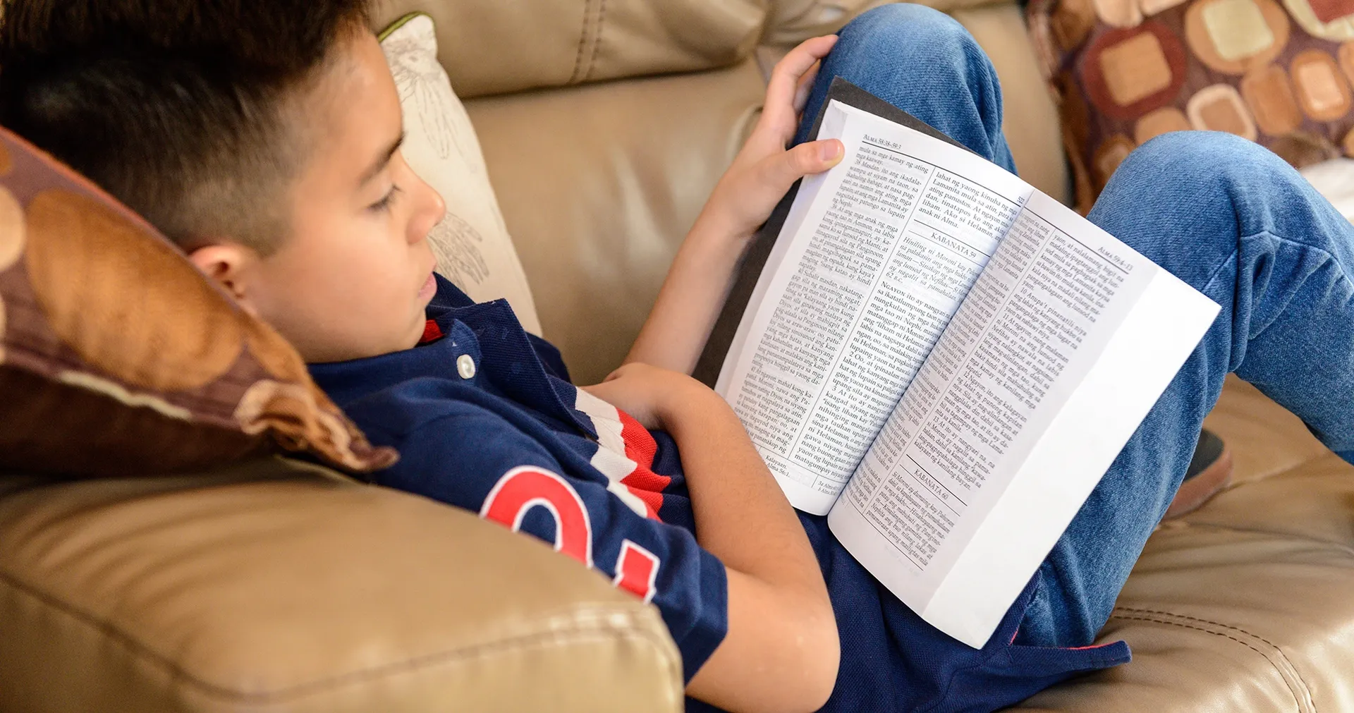 Boy reads the Book of Mormon in Tagalog.