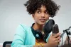 woman talking on microphone in sound studio