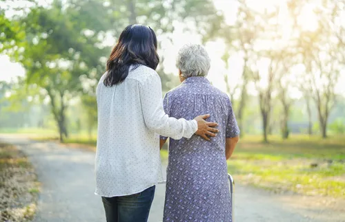 young woman helping elderly woman
