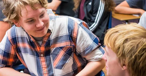 two young men talking at school