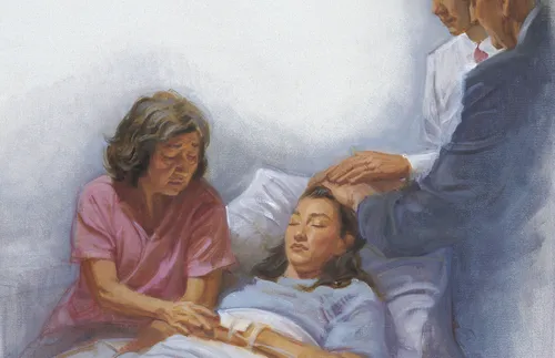woman in hospital bed receiving a priesthood blessing