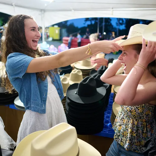 young women trying on hats