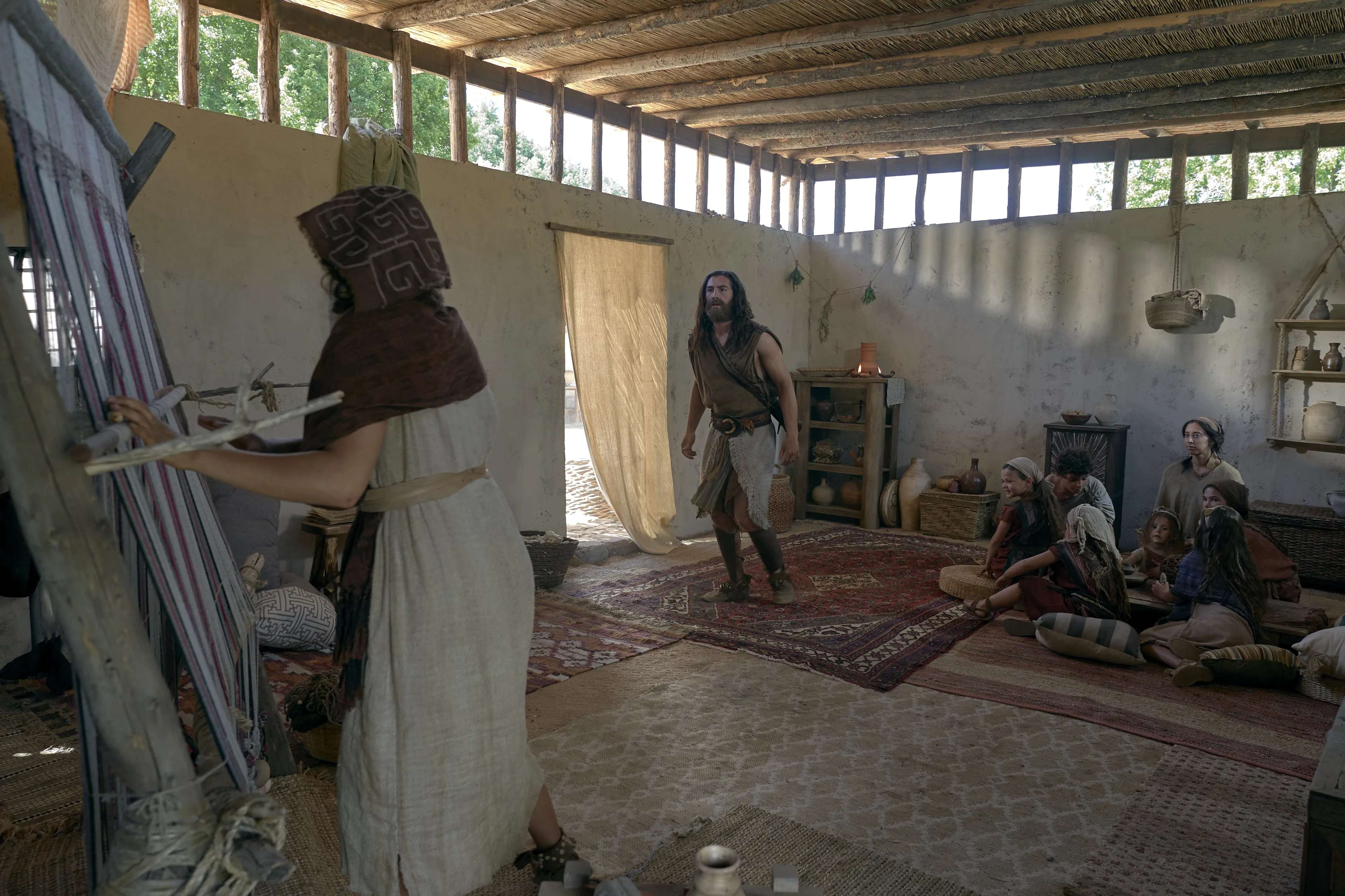 Nephi runs into his home to warn his family of Laman and Lemuel's plan to kill him.