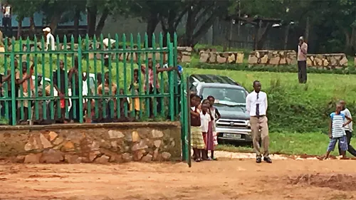 Children outside fence
