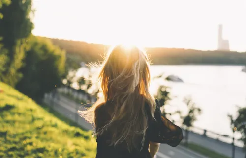 woman staring at a sunset