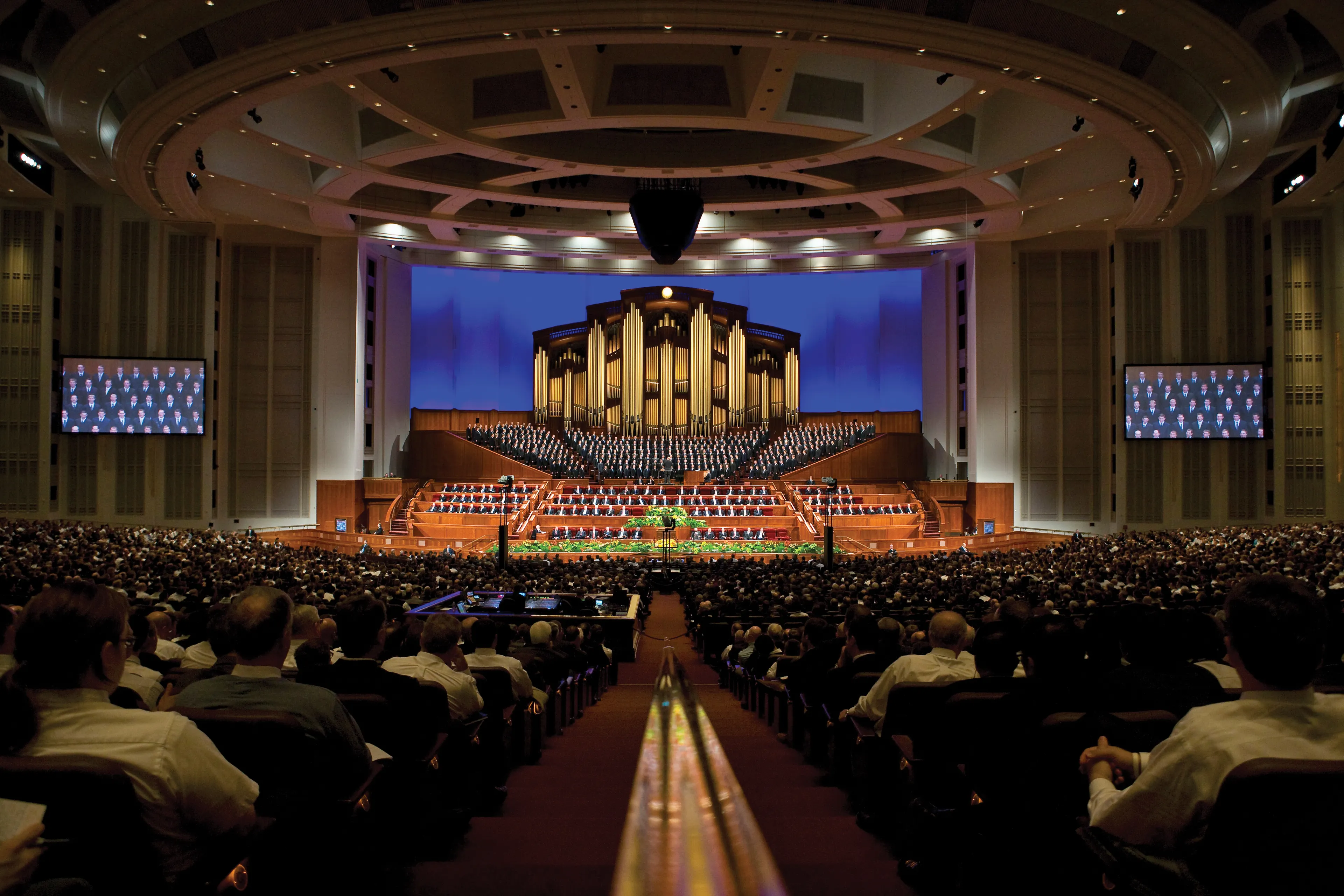The congregation on both sides of the aisle leading to the Conference Center platform.