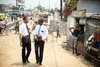 two missionaries walking on a street