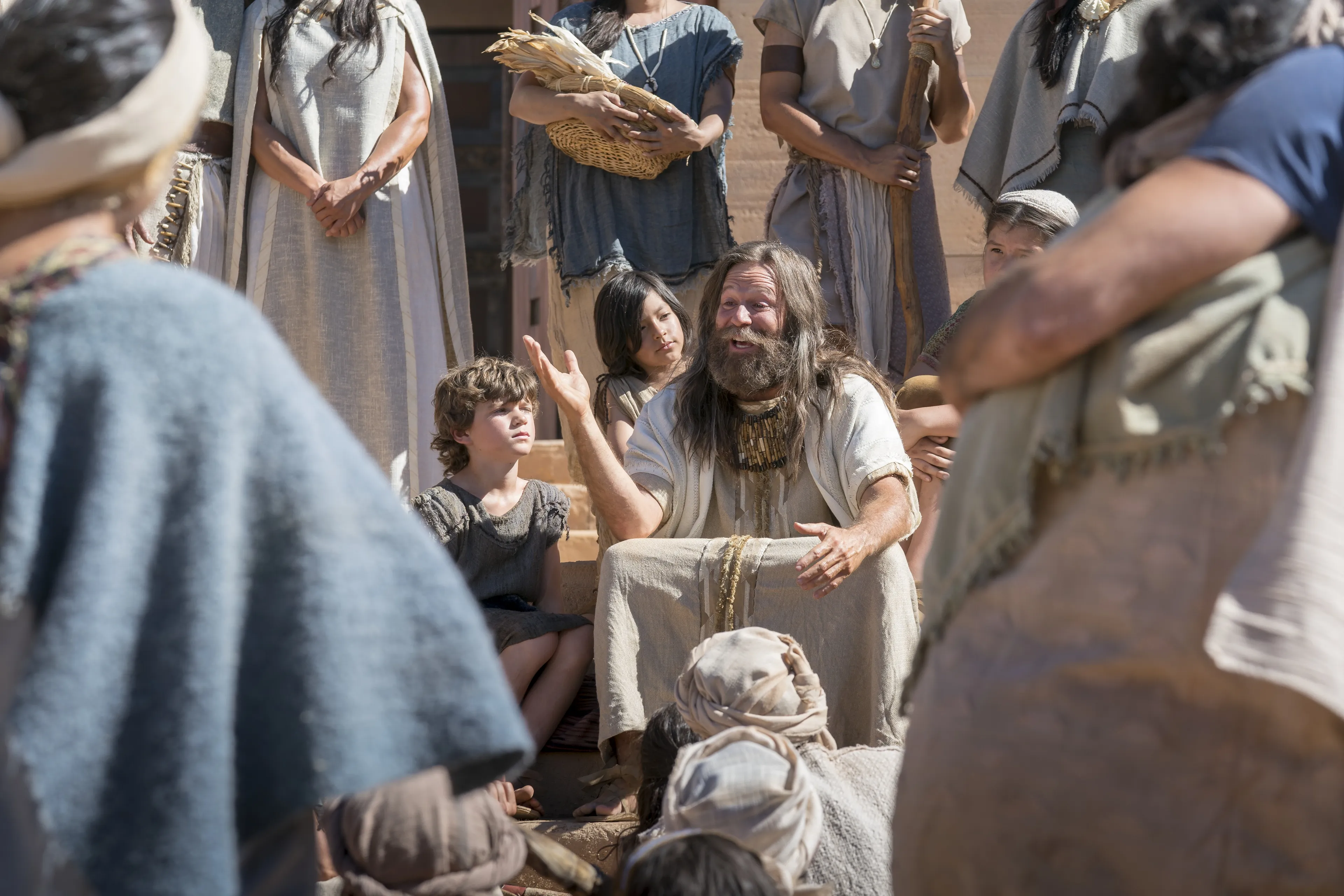 Jacob sitting on the steps of the temple as he teaches the Nephites.