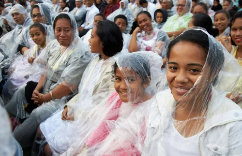 Church members at a devotional in the rain