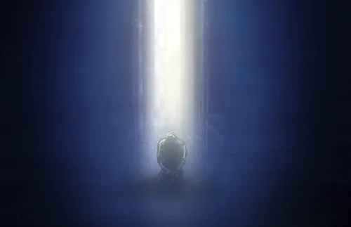 man praying with a pillar of light above him