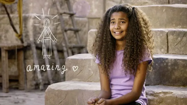 A young girl sits on stone steps.