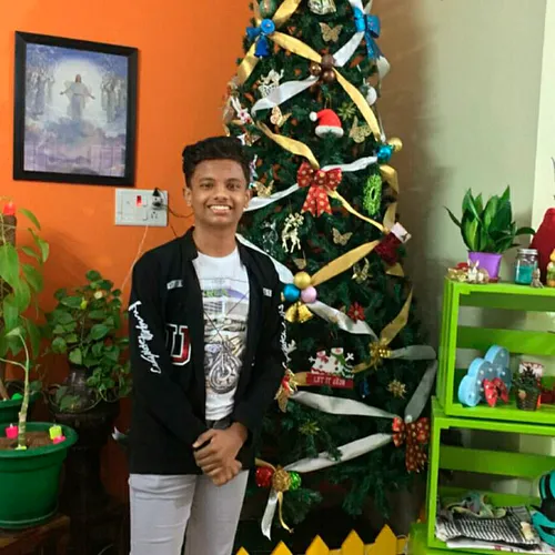 young man by Christmas tree