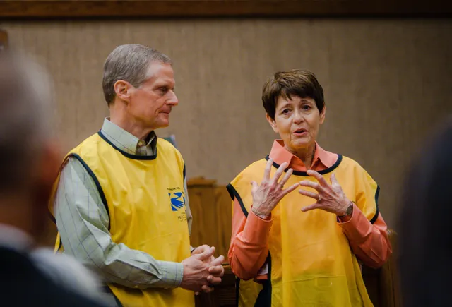 Elder David A. Bednar talks with various people at an LDS Meetinghouse. They are in Fayetteville, North Carolina.